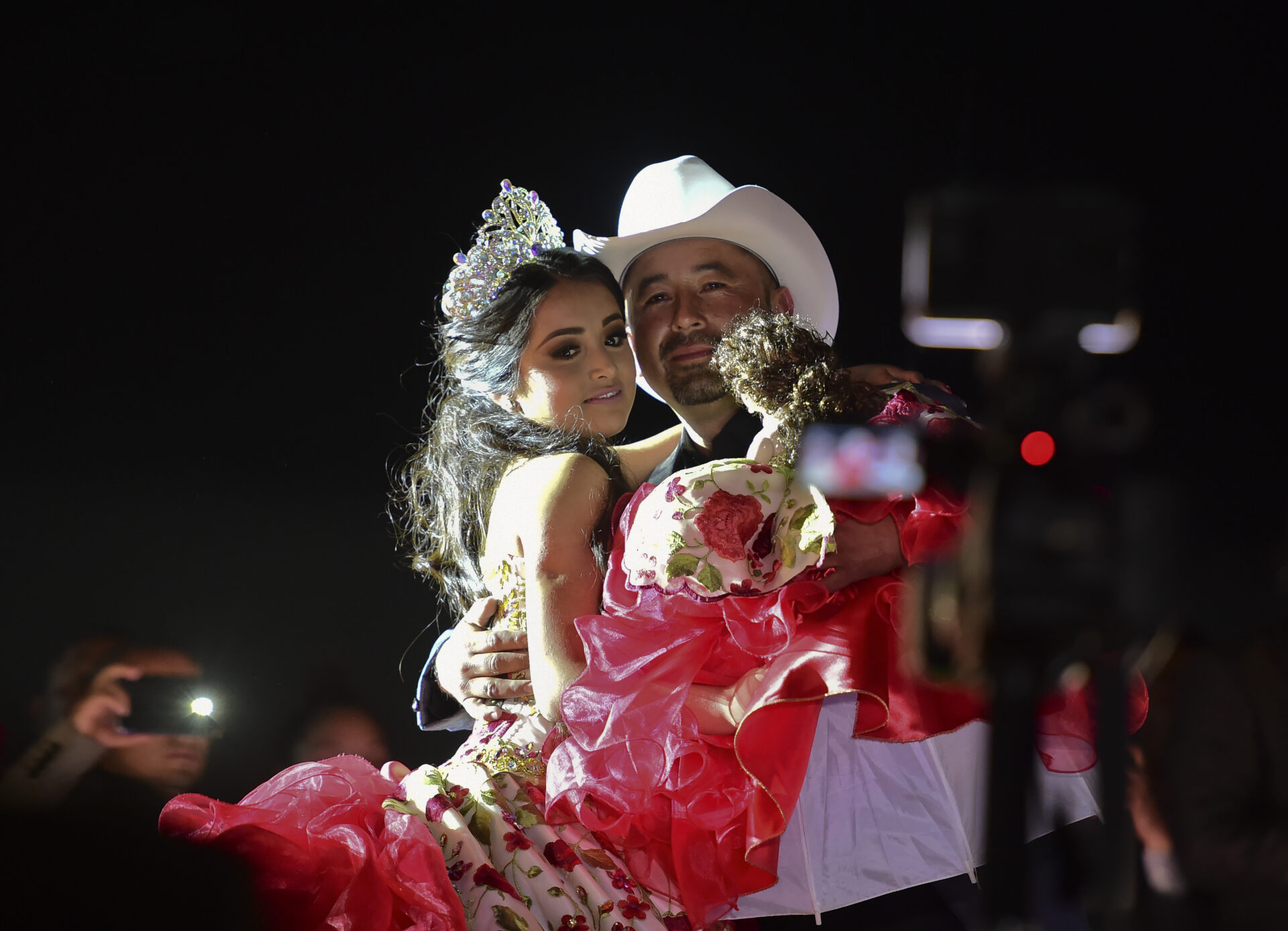 Rubi Ibarra and her father Cresencio Ibarra dance during the celebration of her 15th birthday in Villa Guadalupe, San Luis Potosi State, on December 26, 2016. Rubi, a small-town Mexican teen, welcomed thousands of guests for her 15th birthday party after her parents' video invitation to the milestone event went viral online. / AFP PHOTO / RONALDO SCHEMIDT